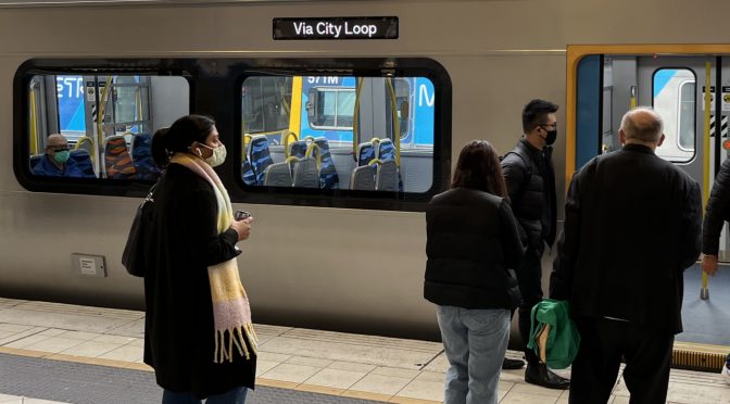 Passengers boarding a train at Flinders Street station